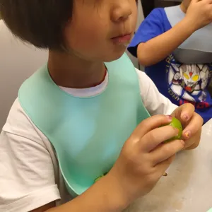 Silicone baby bib waterproof food catcher mint green toddler feeding apron detail view.