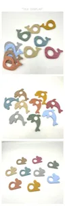 Silicone baby teether detail showing cute whale, dolphin and rabbit shapes in vibrant colors.