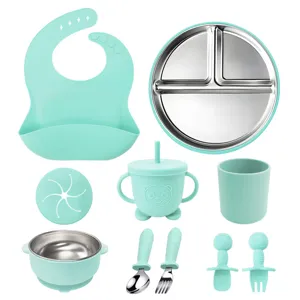 Mint green baby tableware set including stainless steel divided plate, bowl, bib and cups.