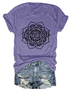 Purple short sleeve t-shirt with thankful mandala graphic paired with ripped denim shorts.