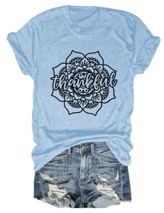 Close-up detail of the light blue short sleeve t-shirt featuring a black mandala graphic print.