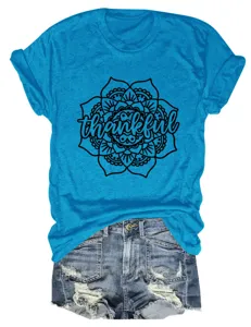 Blue short sleeve women t-shirt with thankful floral mandala print and denim shorts. Detail view.