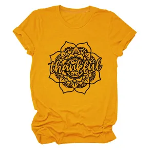Detail view of the retro mustard yellow short sleeve t-shirt featuring a mandala thankful print.