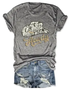 Close-up detail of grey short sleeve t-shirt with cowboy hat print and blue denim shorts.