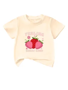 Cute strawberry print detail on the soft cream kids short sleeve t-shirt close up view.