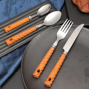 Stainless steel tableware set with wood grain handle, western steak knife fork and spoon.