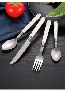 Close-up of a 4-piece stainless steel tableware set with elegant white marble ceramic handles.