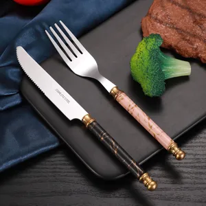 Stainless steel cutlery set with marble texture handle and titanium gold plating for steak.