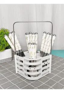 Detailed view of stainless steel tableware set with marble ceramic handles and rack.