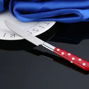 Cuchillo de mesa de acero inoxidable con mango de lunares rojos y blancos para cocina.