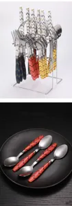 Stainless steel cutlery set detail featuring patterned handles and matching metal storage rack display.