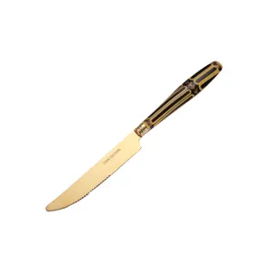 Coltello da bistecca in acciaio inossidabile dorato con elegante manico decorativo da cucina.