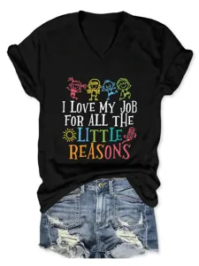Detailed view of black V-neck t-shirt with funny quote graphic and matching denim shorts.