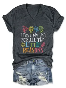 Close-up detail of dark grey V-neck t-shirt with funny teacher typography and cute doodle print.