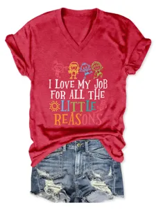 Detailed close-up of a women's red heather graphic T-shirt with fun lettering and denim shorts.