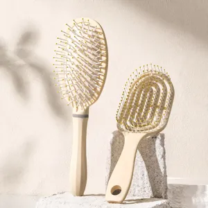Detail shot of the hairbrush set featuring curved massage teeth and ergonomic handle design.