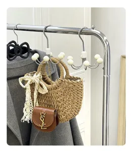 Close-up detail of 360-degree rotatable multi-claw wardrobe hook hanging on metal rack.