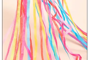 Close-up of colorful paper streamers, vibrant hanging ribbons for party decoration details.