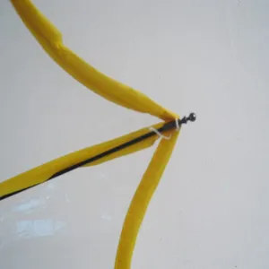 Close-up detail of transparent umbrella rib structure with yellow trim for clear view.