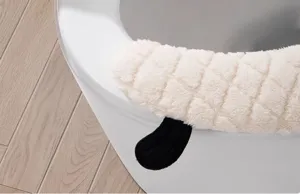 Detailed view of thick plush toilet seat cover with quilted design and cute black animal ear accent.