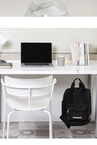 Portable desk hook for hanging school bags and backpacks securely on office or study tables.