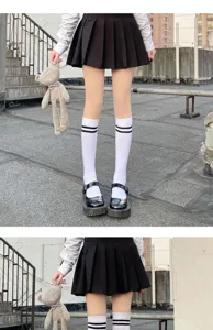 Detail view of women's black and white double stripe knee high socks paired with JK uniform outfit.