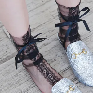 Detailansicht von transparenten schwarzen Netzsocken mit Schleife, ideal für Sommer.