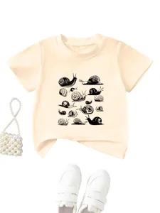 Detailed view of the kids casual short sleeve t-shirt with cute black snail print in apricot.