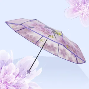 Transparent folding umbrella with beautiful cherry blossom floral pattern for rainy days.