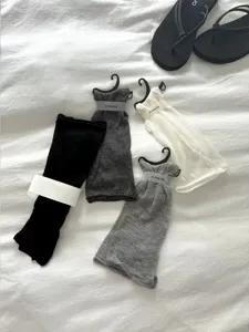 Sheer footless leg warmers detail showing lightweight fabric and cute mini hanger display.