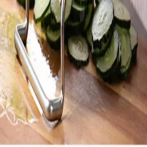 Détail de râpe de cuisine en acier inoxydable montrant la découpe sur planche en bois