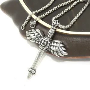 Stainless steel winged sword cross pendant necklace detailed view showing intricate metal texture.