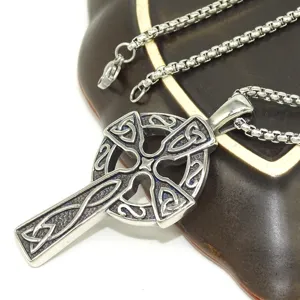 Stainless steel Celtic cross pendant necklace detail showing intricate knotwork texture.