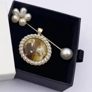 Elegant pearl brooch with vintage photo tray, perfect for wedding bouquets and gifts.
