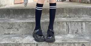 Black knee high socks with white double stripes and cute platform Mary Jane shoes.