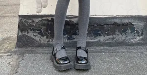 Stylish grey long socks paired with black platform shoes, showcasing a trendy daily streetwear look.