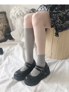 Grey floral pattern mid calf socks paired with stylish black Mary Jane platform shoes for women.