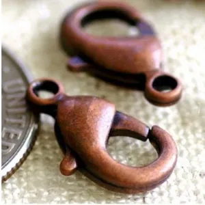 Close-up detail of vintage bronze lobster clasps for DIY jewelry making.