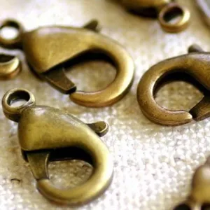 Close-up detail of antique bronze lobster clasps, perfect for DIY jewelry making and crafts.