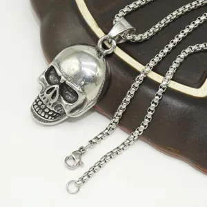 Stainless steel skull pendant necklace, punk style men's jewelry close-up detail shot.