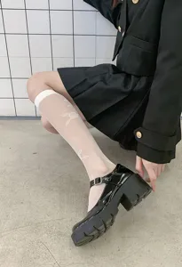 Sheer knee high socks detail showing delicate white rose pattern and retro design style match.