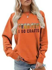 Close-up detail of women orange sweatshirt featuring I DO CRAFTS beer glasses graphic print.
