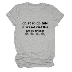 Close-up detail of grey short sleeve tee featuring fun crochet theme print and text graphics.
