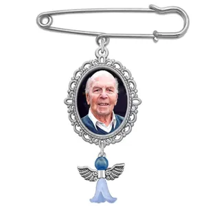 Detailed view of silver DIY photo frame brooch tray with vintage oval pendant and angel charm.