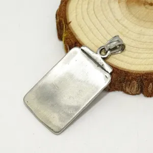 Stainless steel vintage rectangular pendant detail shot showing metal texture and craftsmanship.