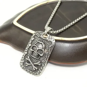 Stainless steel skull pendant necklace with box chain, punk style men jewelry detail view.