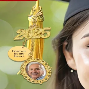 Detail shot of DIY graduation cap tassel charm with 2025 year pendant and memorial photo frame.