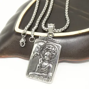 Detailed view of vintage stainless steel pendant necklace with intricate engraved relief design.