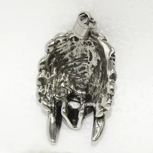 Detail view of the stainless steel Indian mask pendant, showing the exquisite metal texture.