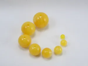 Yellow resin imitation amber round loose beads detail shot for DIY jewelry making and bracelets.
